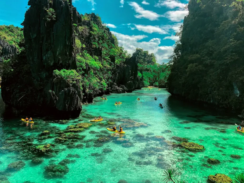best esim for philippines 2026 el nido lagoon palawan turquoise water kayaks limestone cliffs