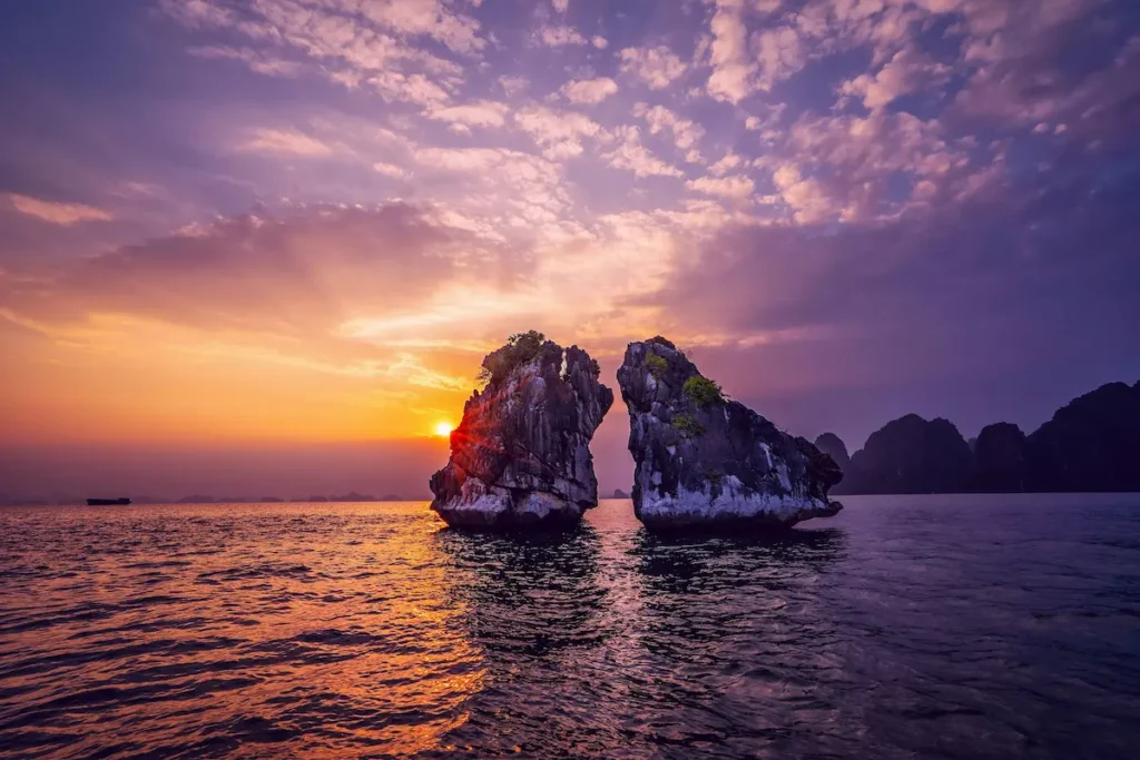 Ha Long Bay sunset in Vietnam with limestone islands and ocean view