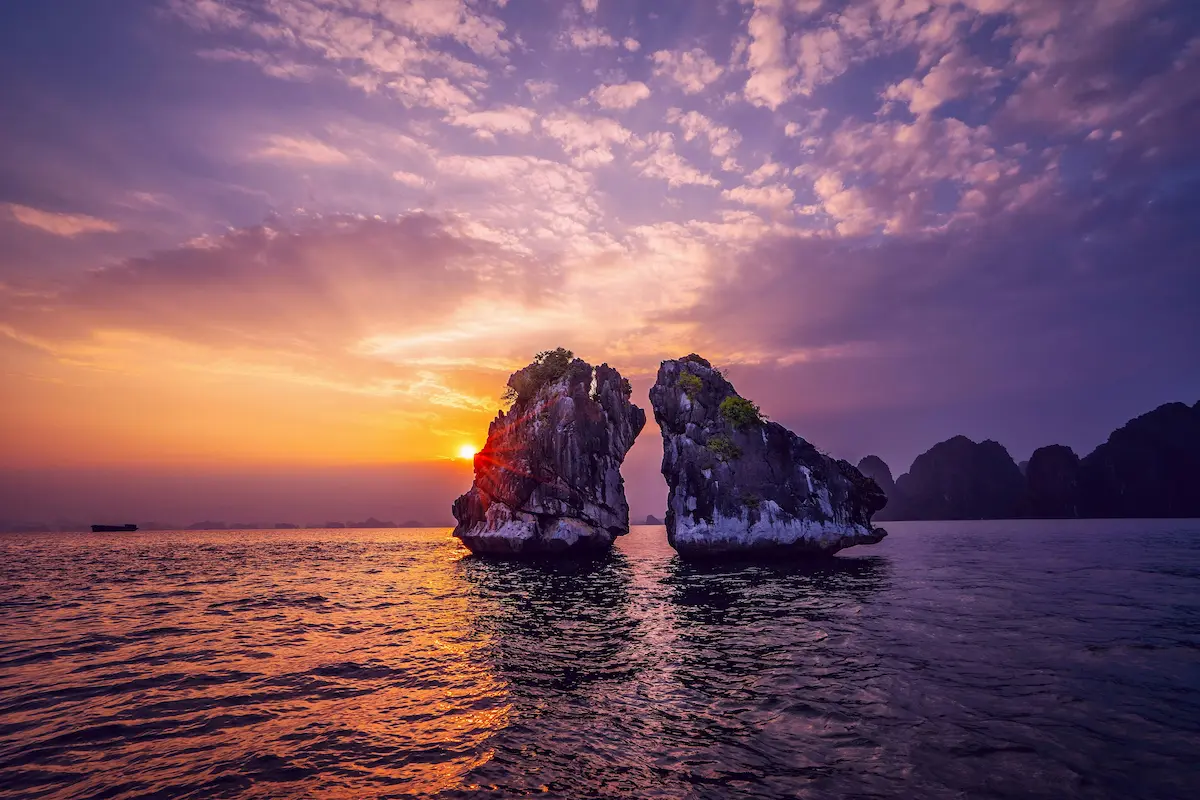 Ha Long Bay sunset in Vietnam with limestone islands and ocean view