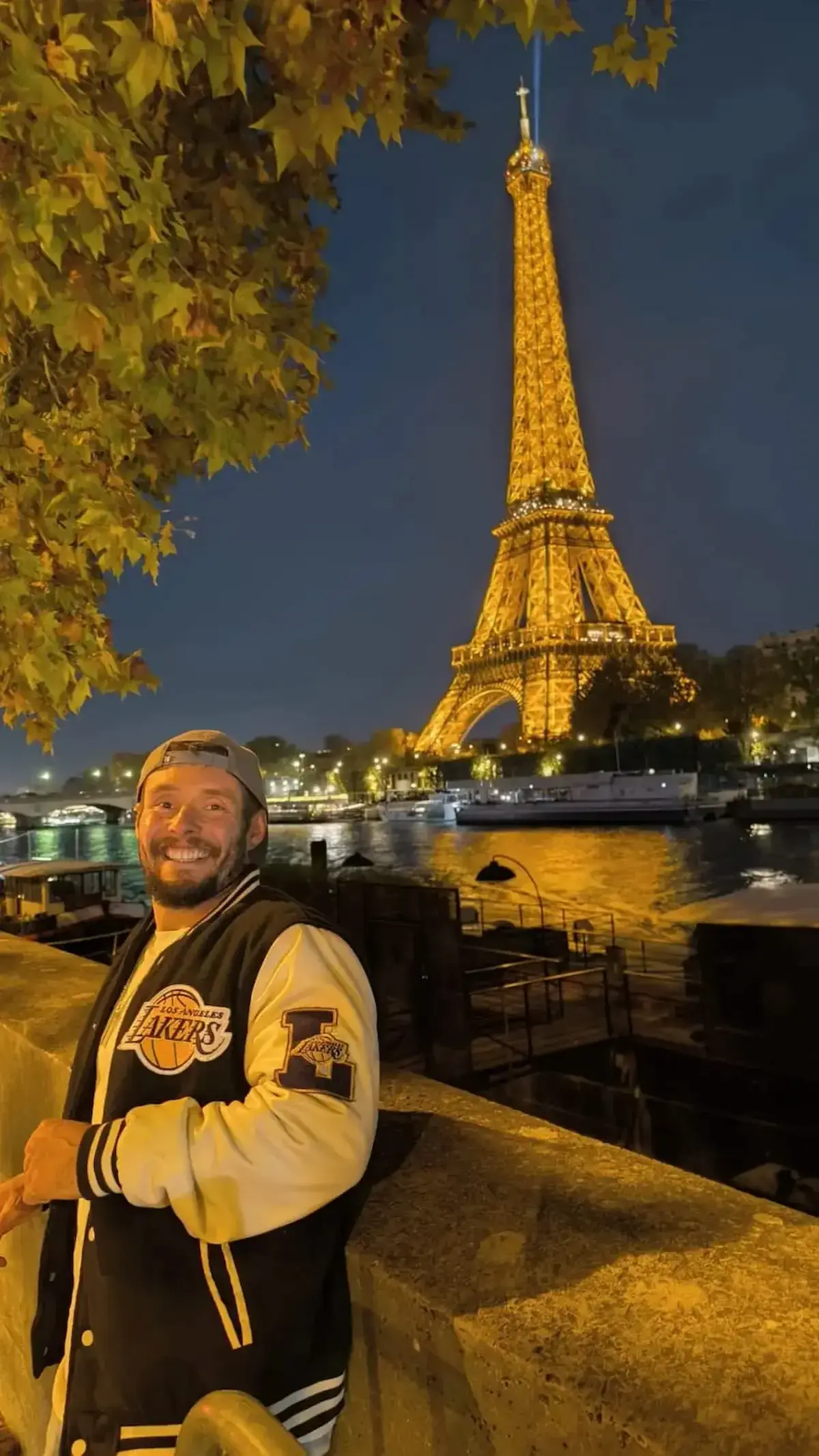 traveler in Paris at night Eiffel Tower illuminated France travel real experience Seine river view