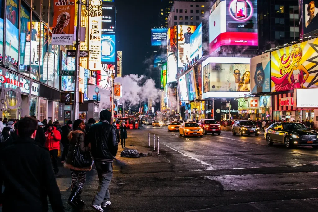 Times Square New York at night with neon lights, taxis and crowds — best eSIM for USA travel 2026