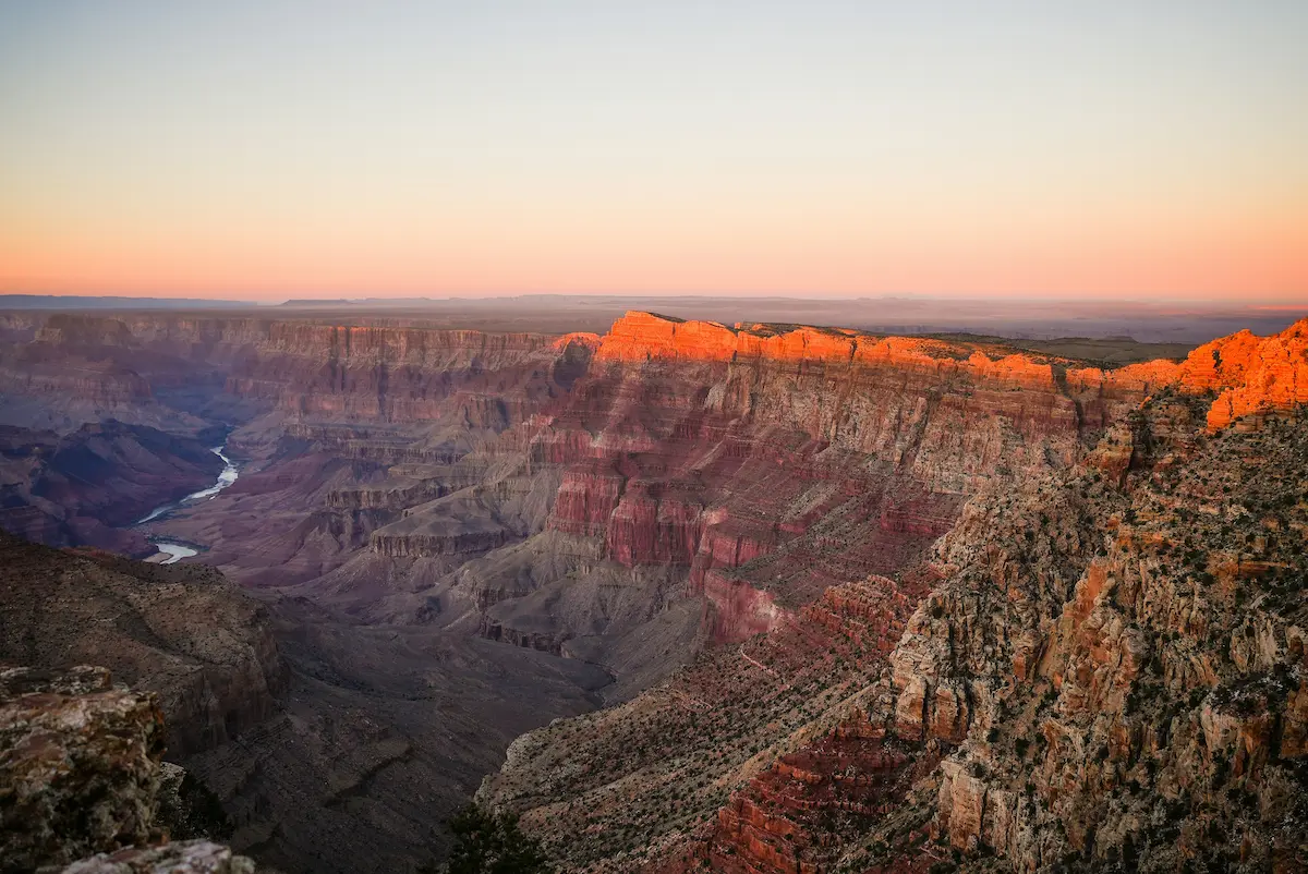 Grand Canyon at sunset with Colorado River and dramatic canyon cliffs — USA travel eSIM coverage 2026