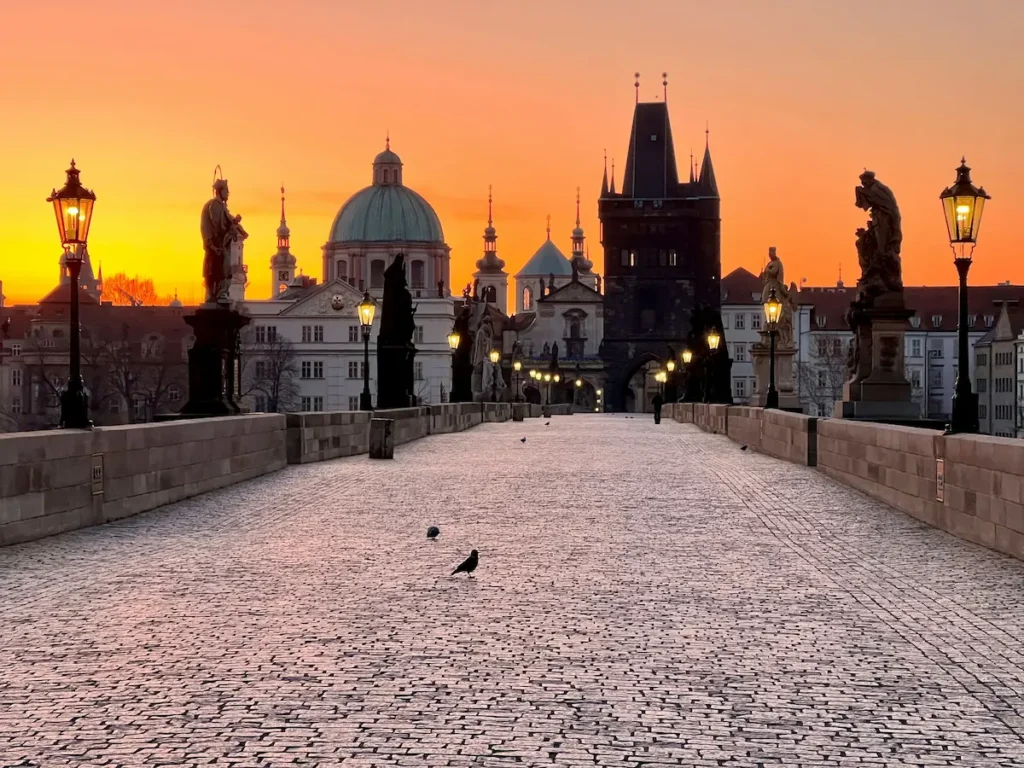 Charles Bridge at sunrise with Prague Castle skyline in the Czech Republic