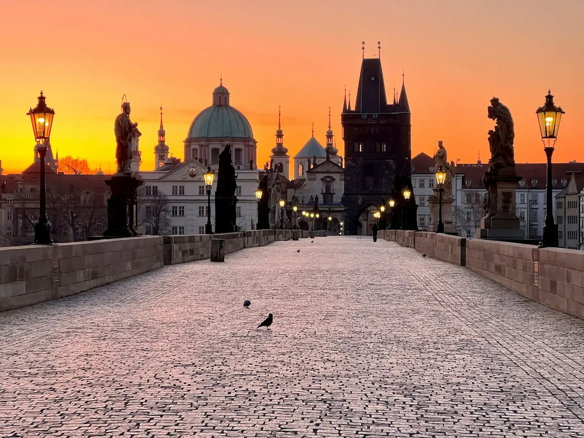 Charles Bridge at sunrise with Prague Castle skyline in the Czech Republic