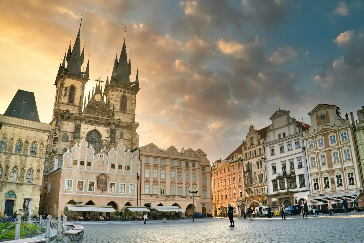 Old Town Square in Prague at sunrise with golden light and historic buildings Czech Republic