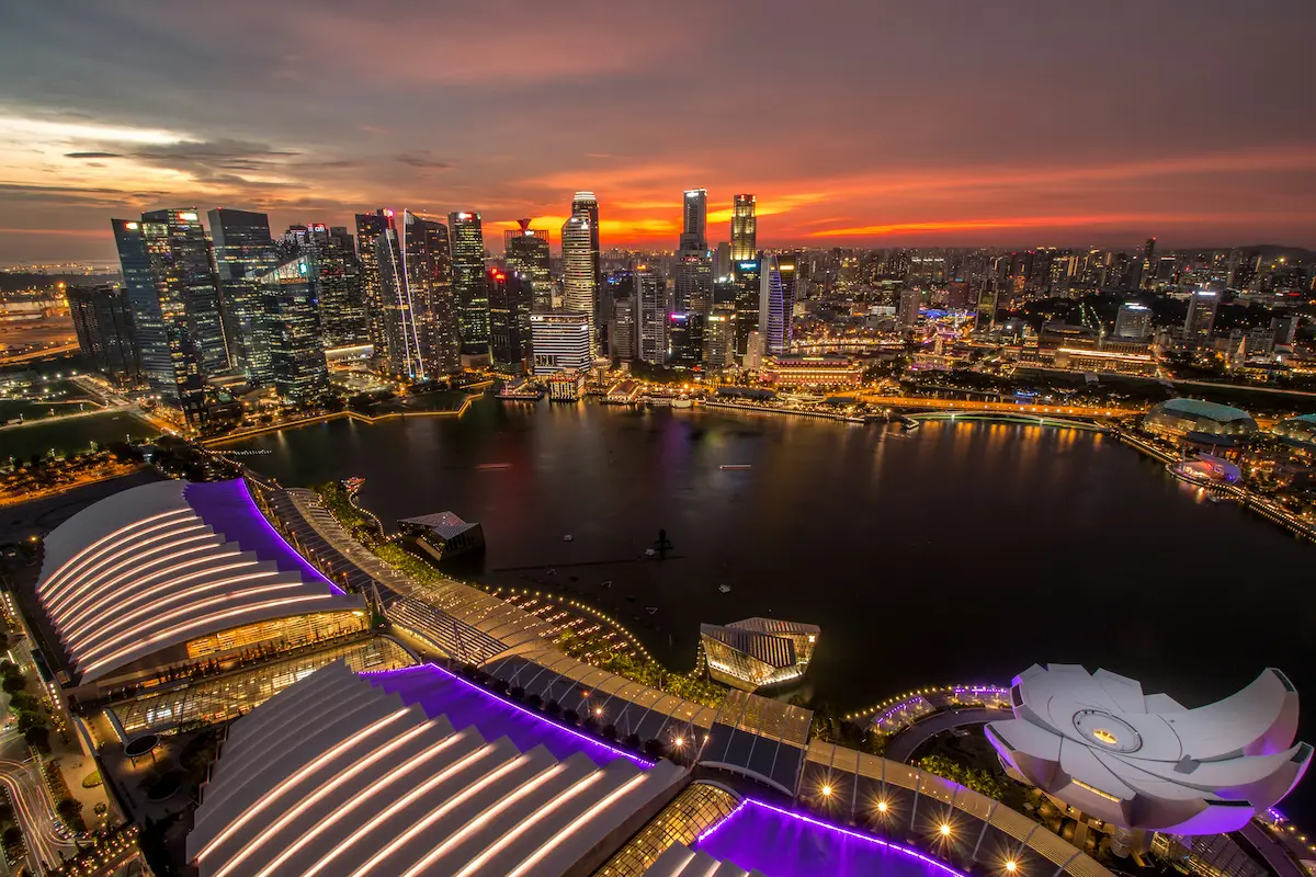 Singapore skyline at sunset with Marina Bay skyline lights reflection and full city view from above