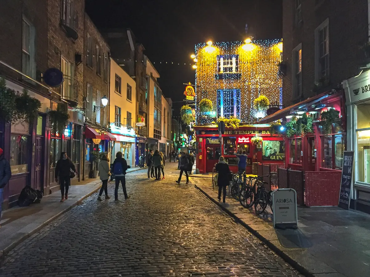 Temple Bar Dublin night street lights rainy cobblestone Ireland nightlife
