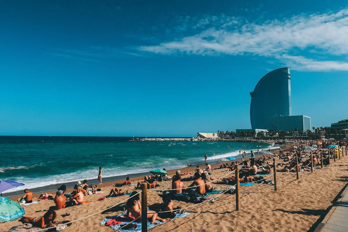 Barceloneta beach crowded in Barcelona during summer with heavy mobile network congestion and tourists using data